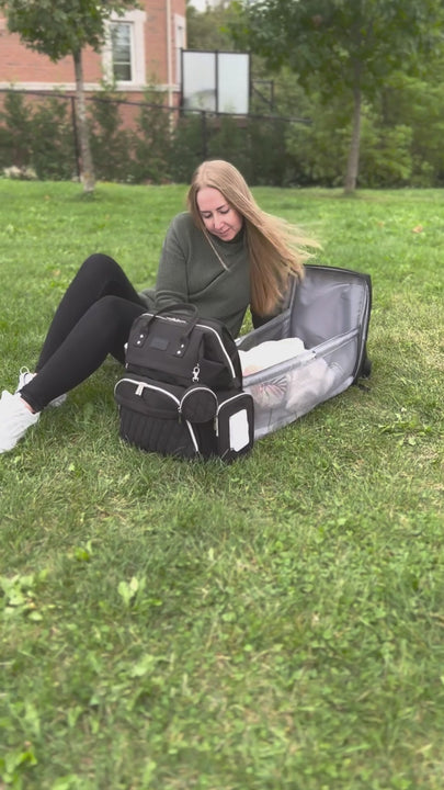 Video displaying a diaper bag with a changing station the unfolds in seconds for the baby lay inside. Clips to the stroller and great agronomic fit on the shoulders. 