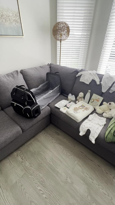 Video is displaying the diaper bag with a bassinet being packed with baby essentials required when on the go. There are lots of storage, wet nap compartment with quick access, pockets for baby bottles.