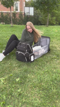 Load and play video in Gallery viewer, Video displaying a diaper bag with a changing station the unfolds in seconds for the baby lay inside. Clips to the stroller and great agronomic fit on the shoulders. 
